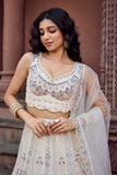 Adorned Cream Net Sequins & Thread Embroidered Bridal Lehenga Set